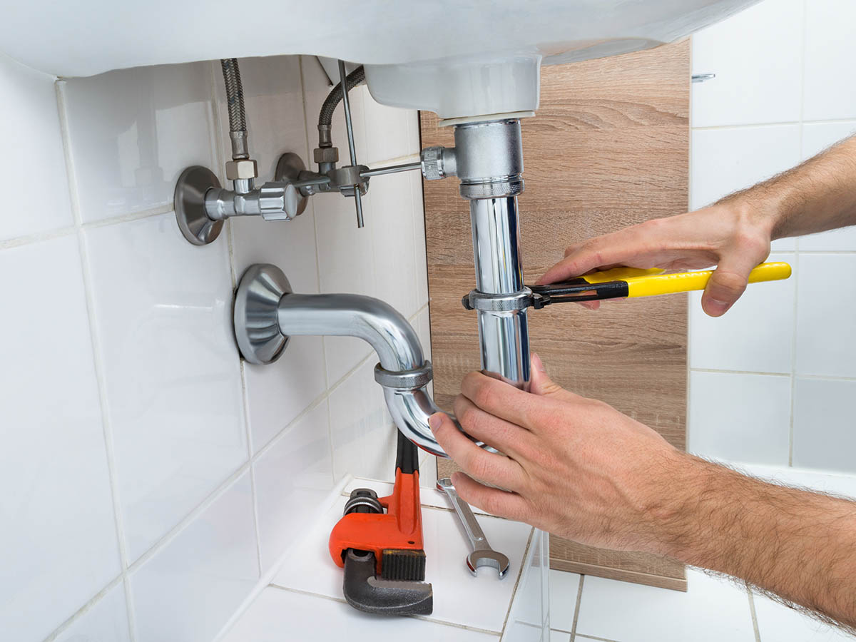 Plumber man with tools isolated over white background