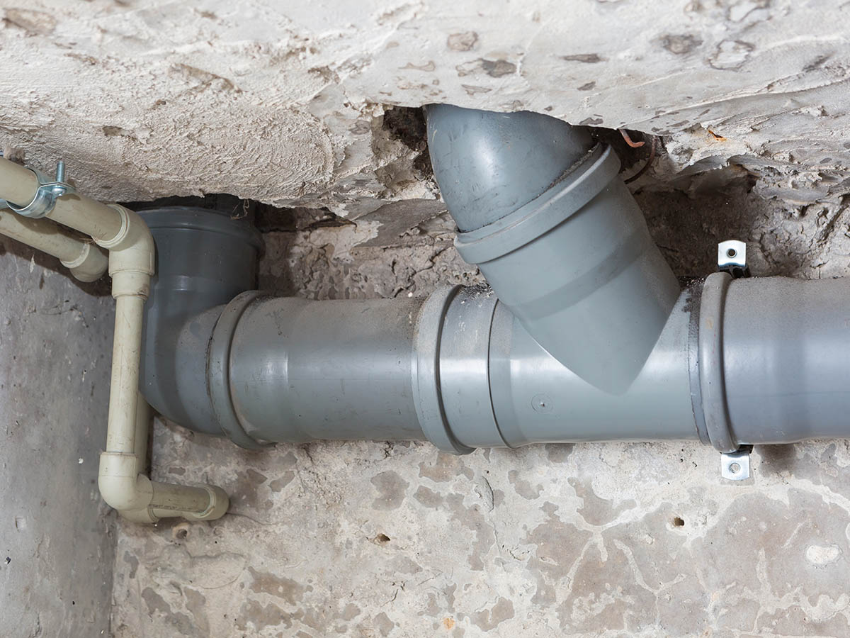 Plumber man with tools isolated over white background