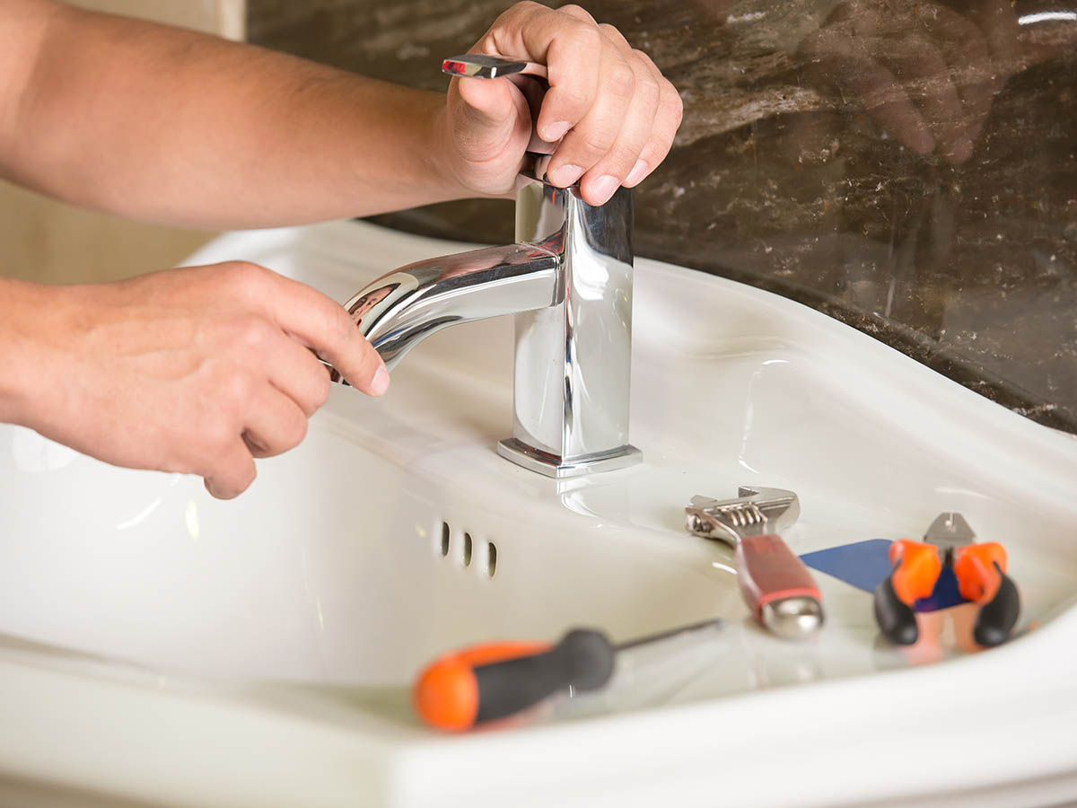 Plumber man with tools isolated over white background