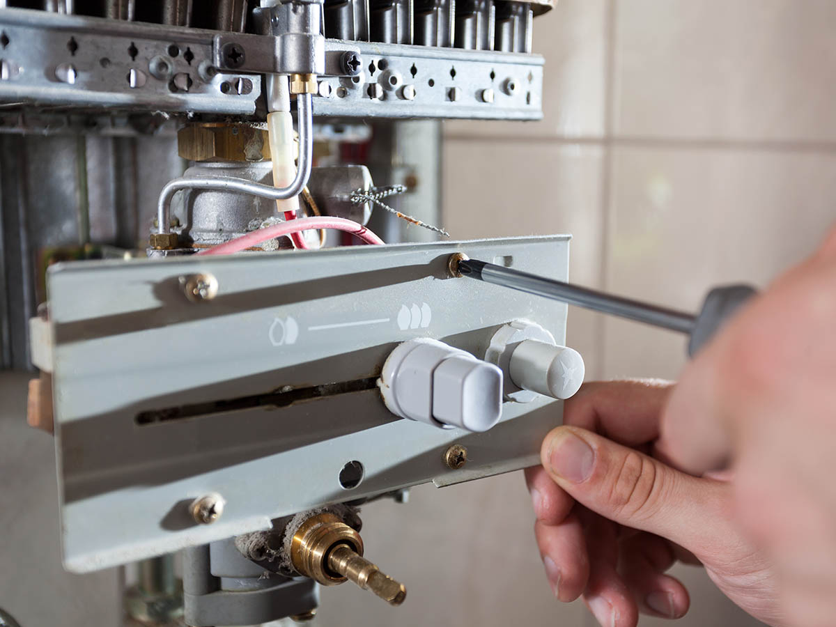 Plumber man with tools isolated over white background